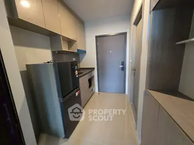 Modern kitchen with sleek cabinetry and stainless steel appliances in compact layout.