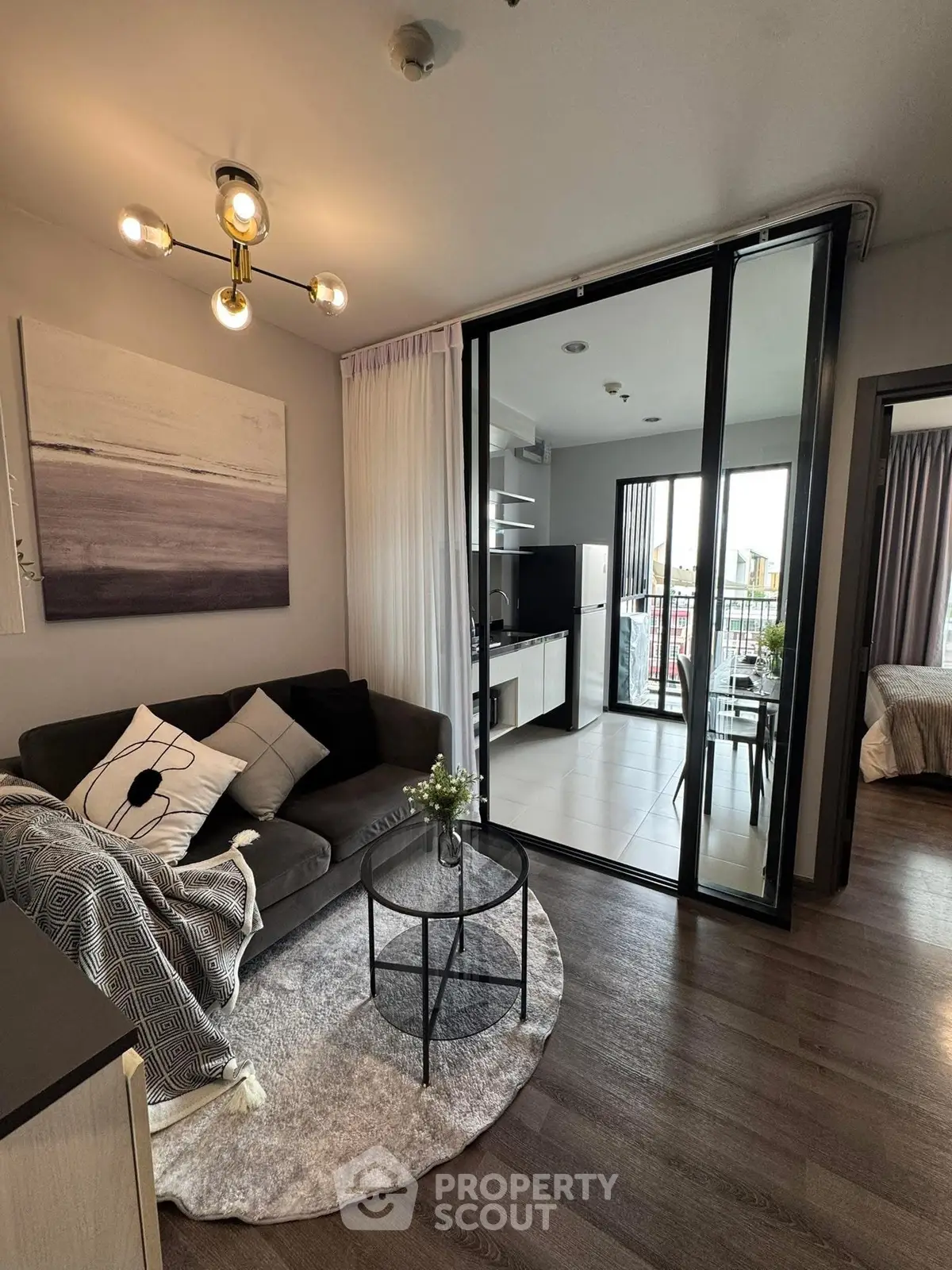 Modern living room with stylish decor and open balcony view