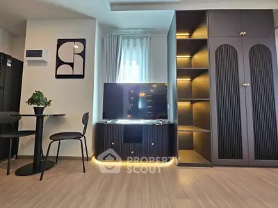 Modern living room with sleek black furniture and ambient lighting