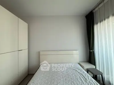 Modern minimalist bedroom with white furniture and large window