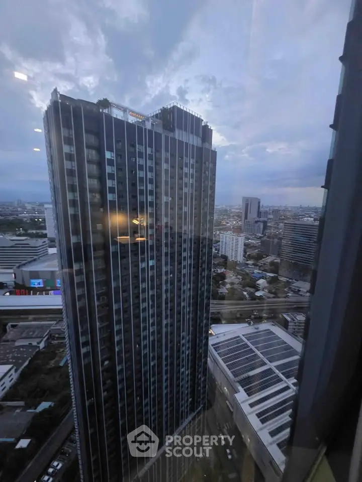 Stunning cityscape view from a high-rise building window, showcasing urban skyline and modern architecture.