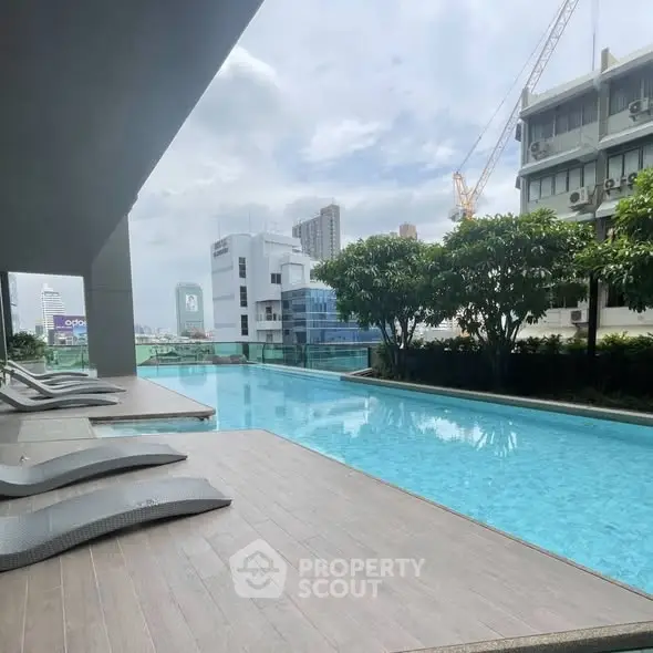 Luxurious rooftop pool with city skyline view, perfect for relaxation and leisure.