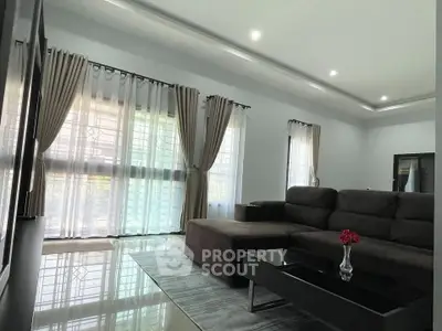 Spacious living room with modern decor and large windows for natural light.