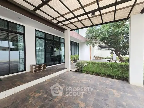 Spacious modern entrance with garden view and stylish flooring