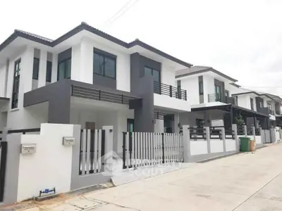 Modern two-story homes with sleek design and gated entrance in a suburban neighborhood.