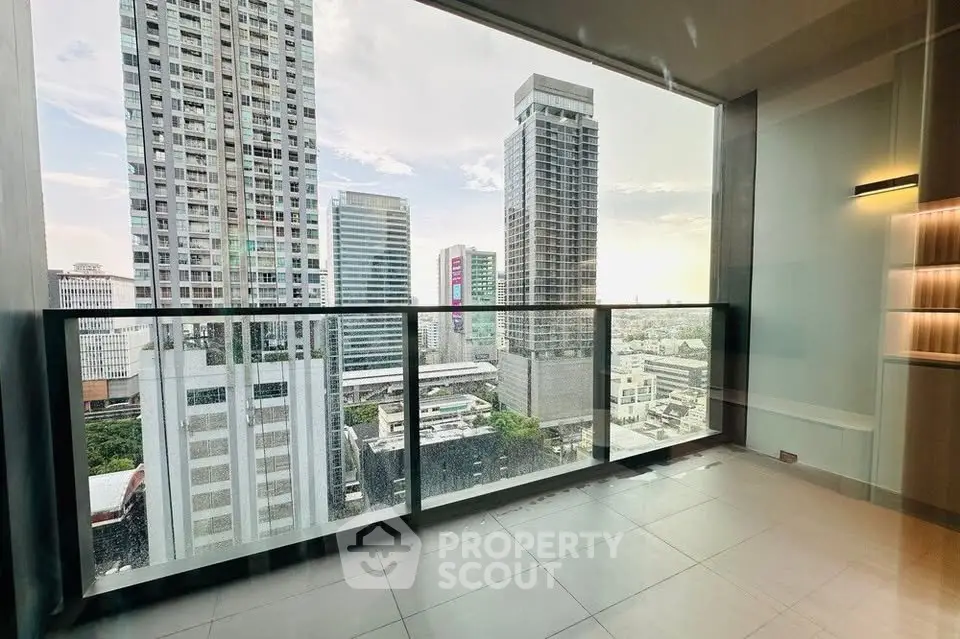 Stunning high-rise apartment with panoramic city views and spacious balcony.