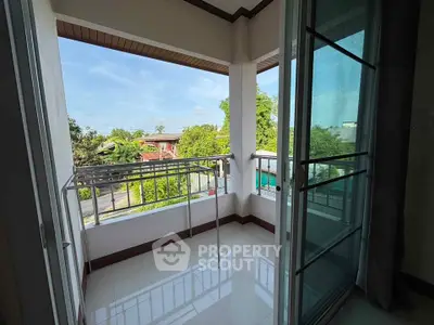 Spacious balcony with scenic view and sliding glass doors in modern apartment.