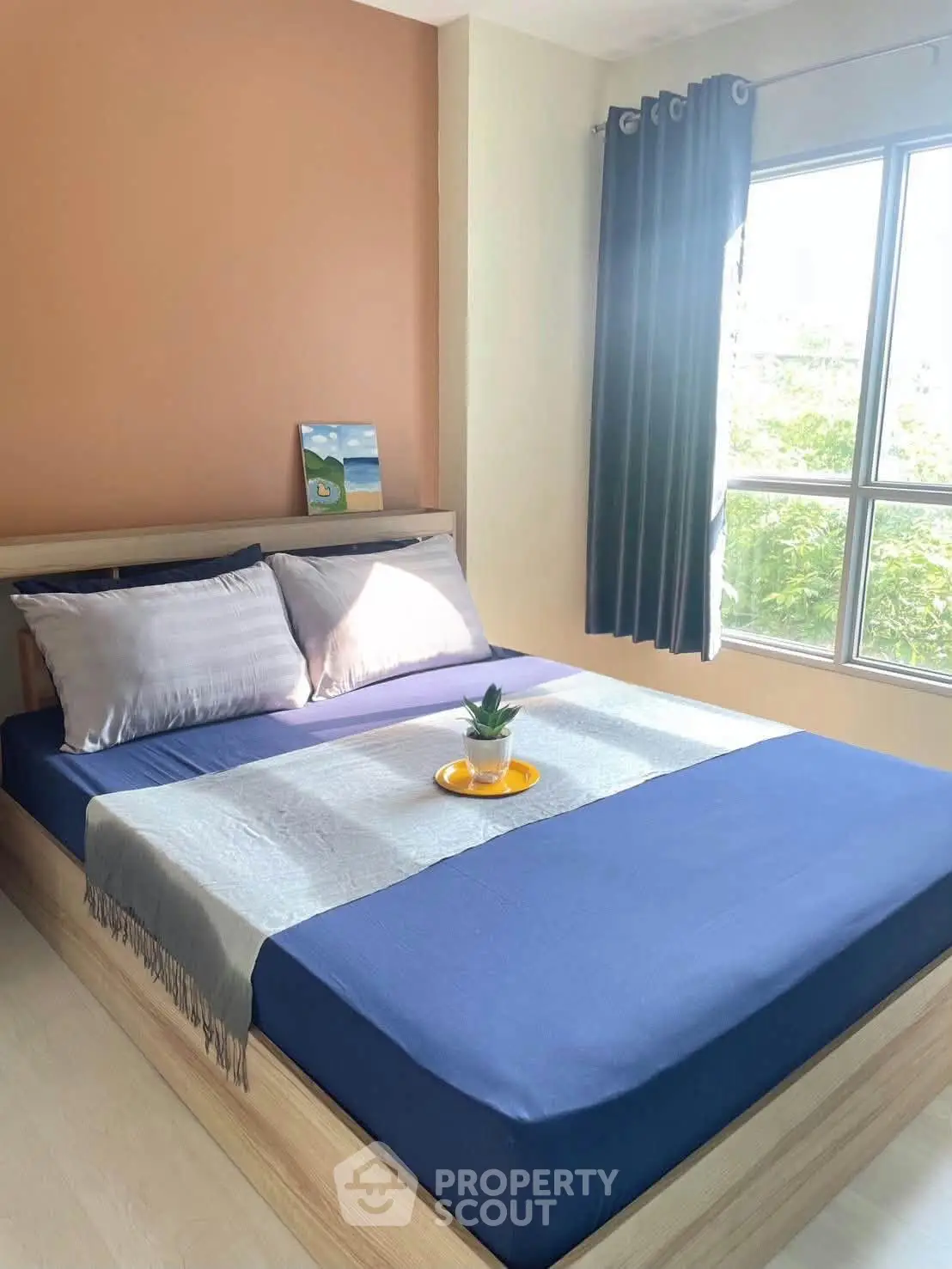 Cozy bedroom with natural light and modern decor, featuring a comfortable bed and stylish curtains.