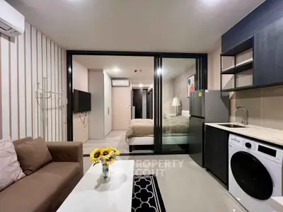 Modern studio apartment with open layout, featuring a cozy living area, compact kitchen, and stylish bedroom.