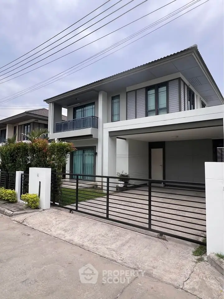Modern two-story house with sleek design and spacious driveway