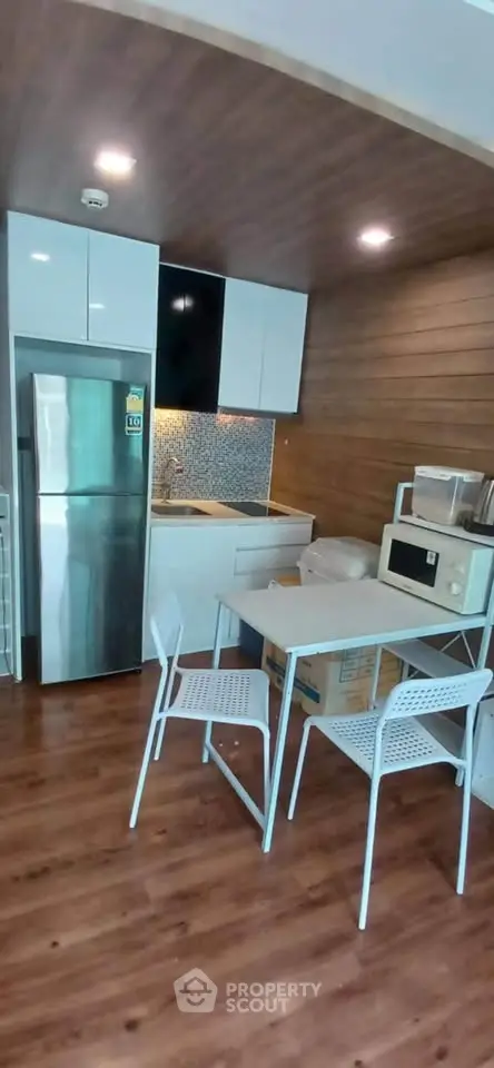 Modern kitchen with sleek appliances and stylish dining area