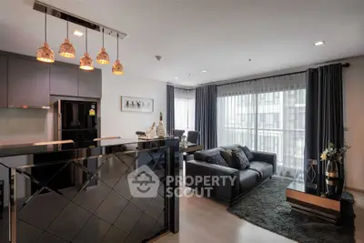 Modern living room with stylish decor and large windows in a luxury apartment.