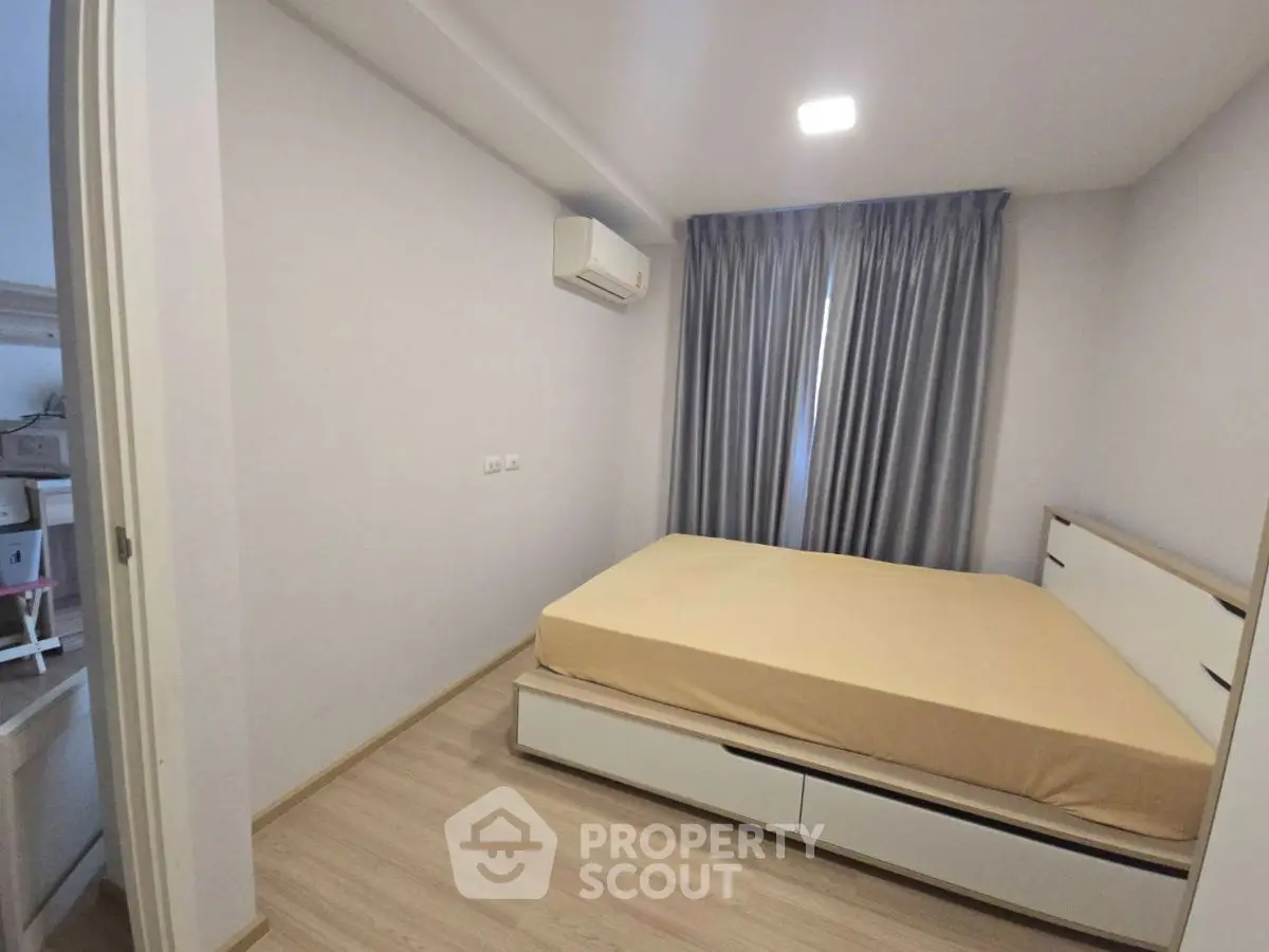 Cozy bedroom with modern design and ample natural light, featuring a comfortable bed and stylish decor.