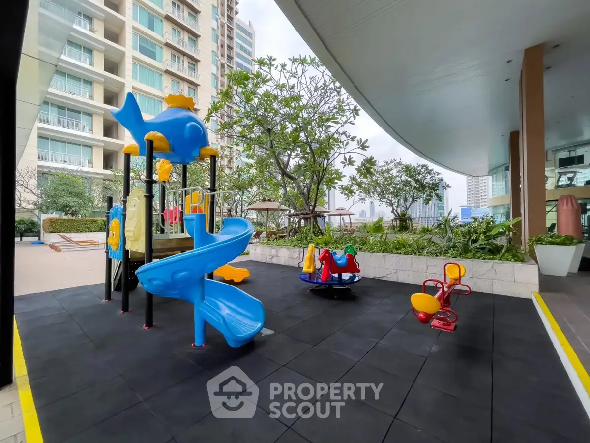 Modern residential building with vibrant playground and lush greenery