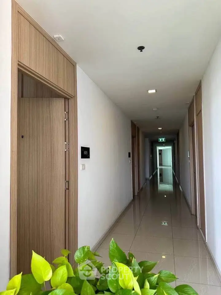 Modern apartment hallway with sleek design and polished floors.
