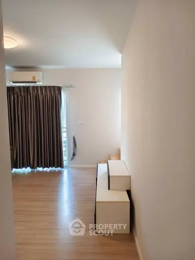 Modern living room with wooden flooring and stylish curtains