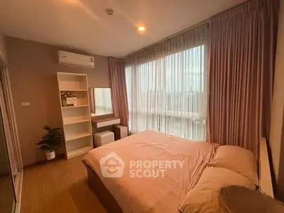 Cozy bedroom with large window and soft lighting, featuring elegant curtains and a stylish vanity area.