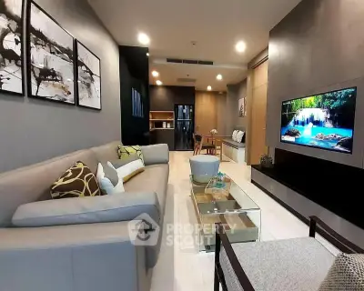 Modern living room with stylish decor and wall-mounted TV in a cozy apartment.