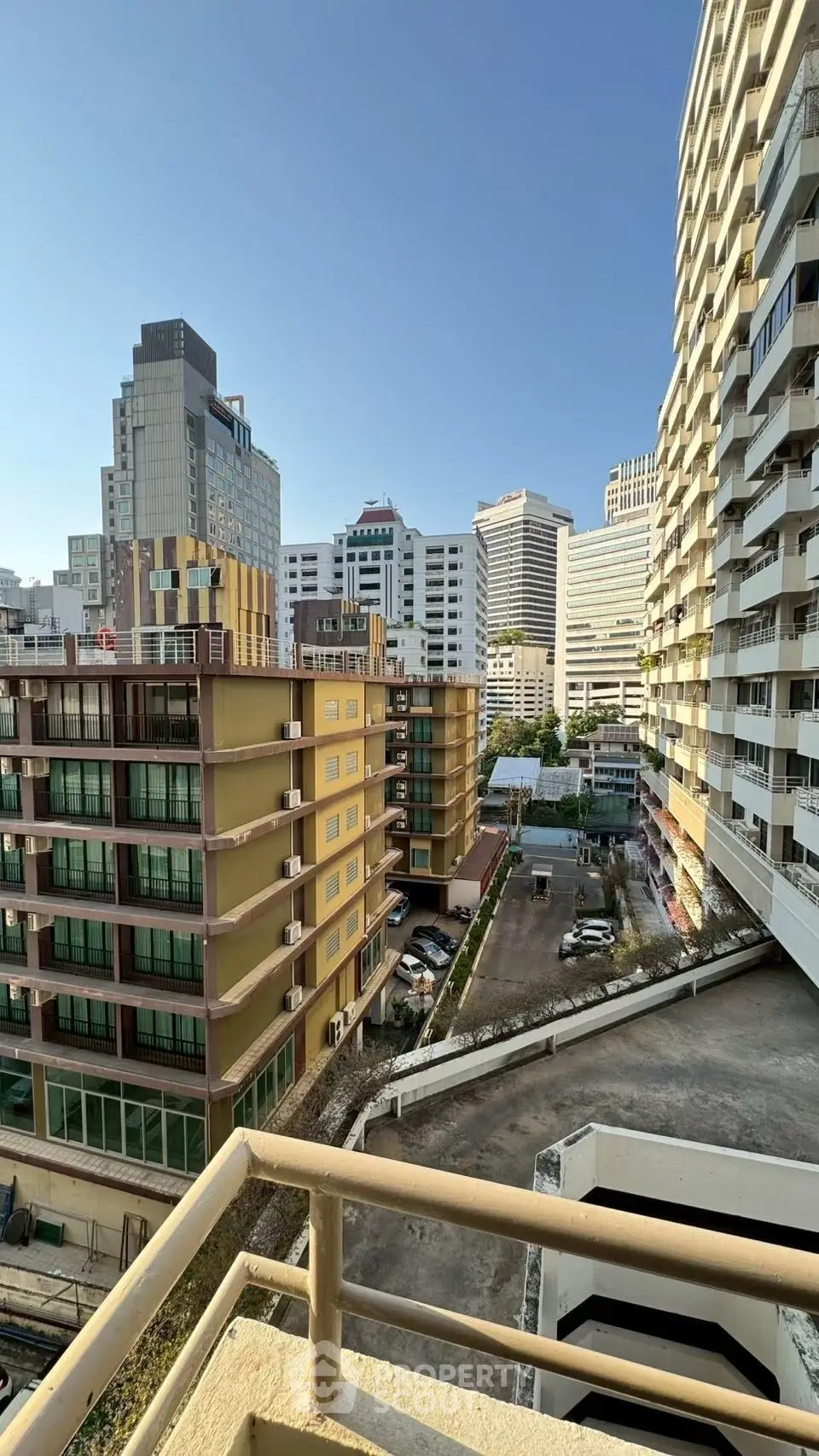 Stunning urban view from a high-rise balcony showcasing city skyline and modern architecture.