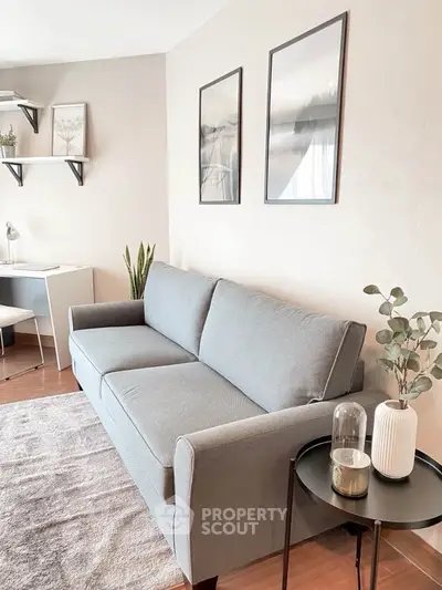 Stylish living room with modern gray sofa, elegant decor, and cozy ambiance perfect for relaxation.