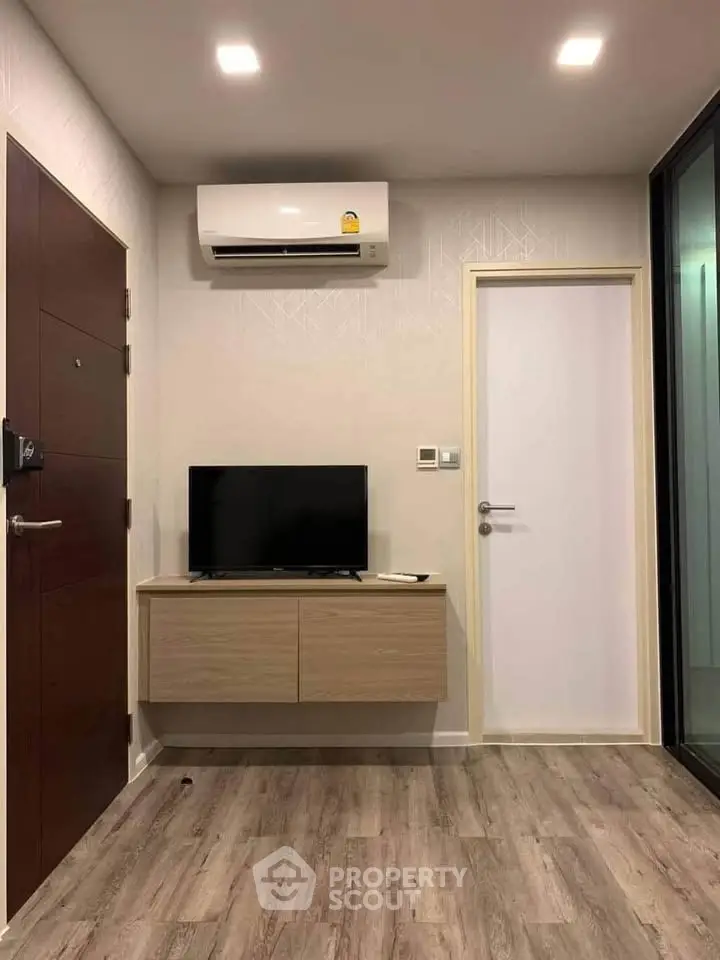 Modern living room with sleek air conditioning and stylish wooden flooring