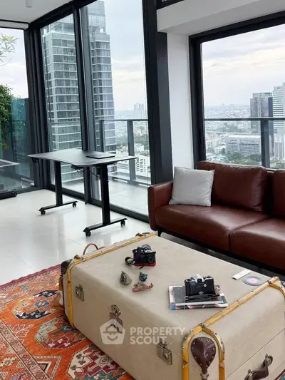 Luxurious living room with panoramic city views and stylish decor in a high-rise apartment.