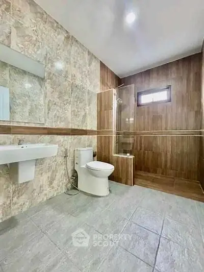Spacious modern bathroom with elegant tile design and walk-in shower