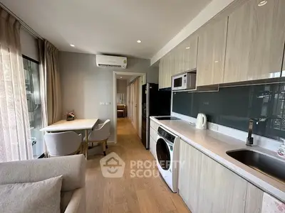 Modern kitchen with sleek cabinetry and integrated appliances in a stylish apartment.