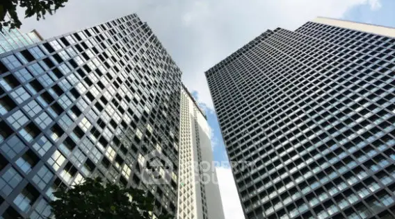 Stunning view of modern high-rise buildings against a clear sky, showcasing urban architectural elegance.