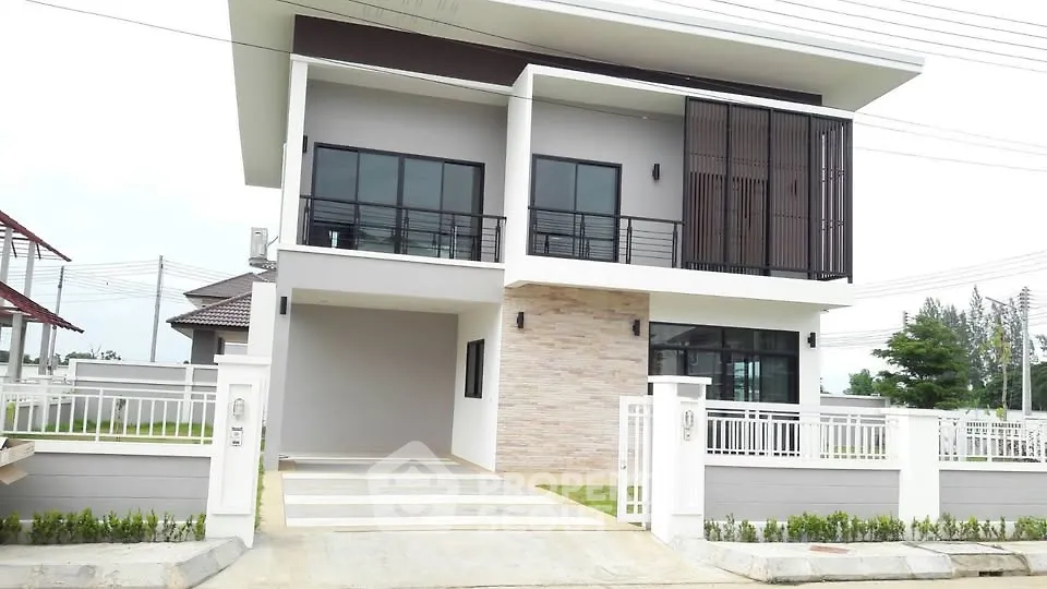 Modern two-story house with sleek design and spacious driveway in a serene neighborhood.