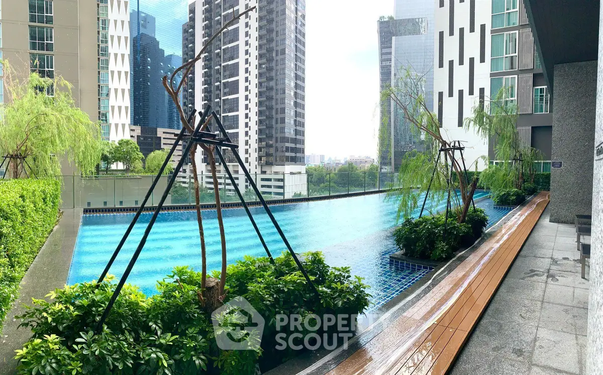 Luxurious high-rise building with stunning rooftop pool and city view.