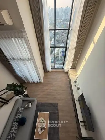 Stunning high-rise living room with floor-to-ceiling windows and breathtaking city view.