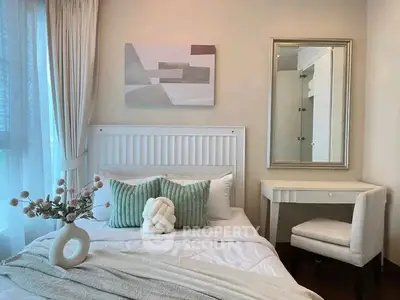 Chic bedroom with modern decor, featuring a cozy bed, stylish mirror, and elegant furnishings.