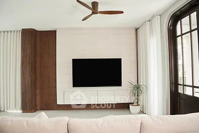 Modern living room with sleek TV setup and elegant wooden accents