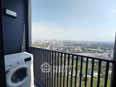 Stunning high-rise balcony with panoramic city views and convenient laundry setup.
