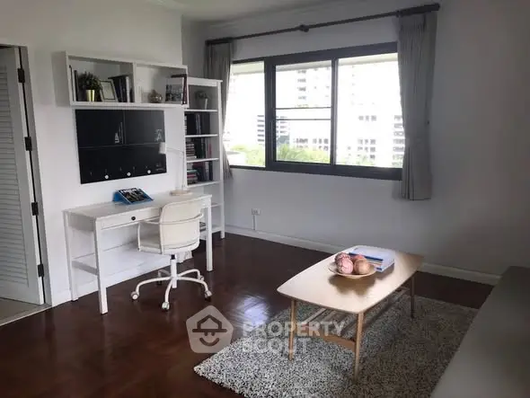 Bright study room with modern desk and large window view.