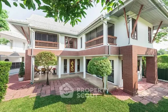Charming two-story house with lush garden and spacious patio, perfect for family living.