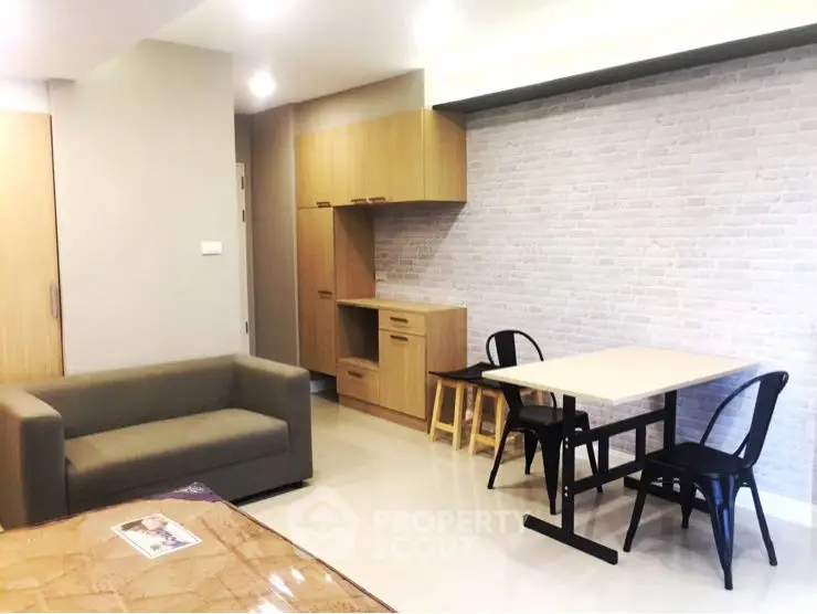Modern living room with stylish furniture and brick accent wall