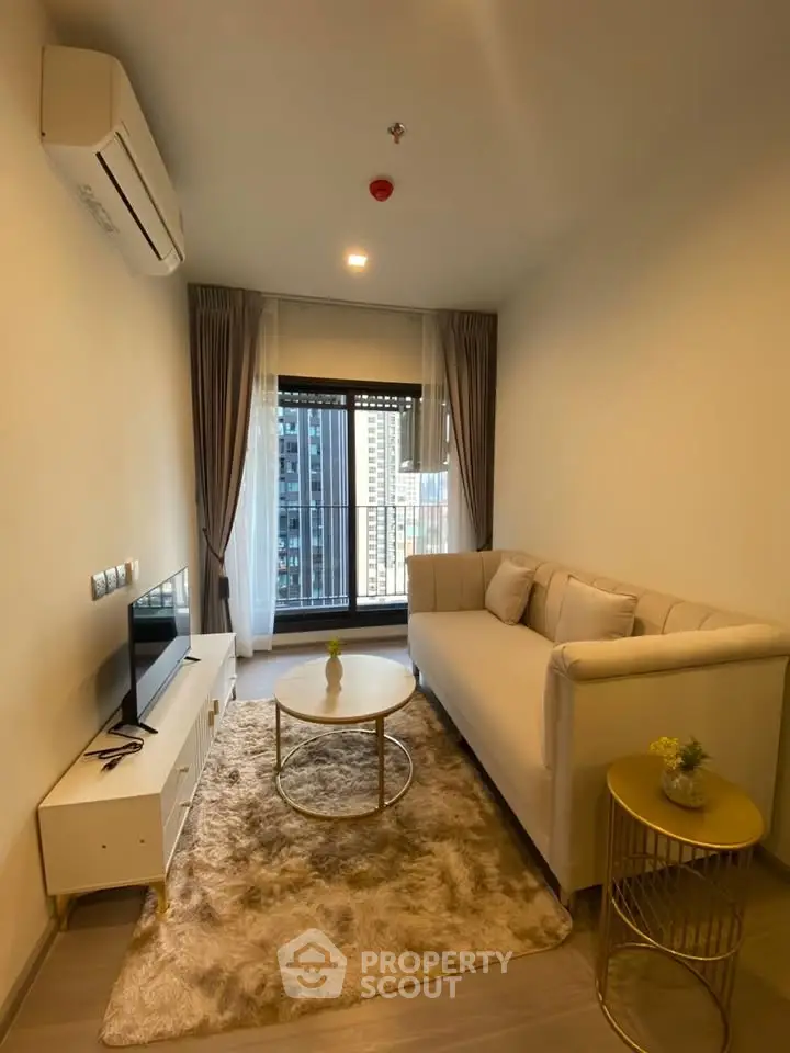 Modern living room with elegant decor and city view, featuring a cozy sofa and stylish coffee table.