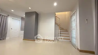 Spacious modern interior with sleek staircase and neutral tones, perfect for customization.