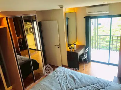 Modern bedroom with balcony access and mirrored wardrobe in a stylish apartment.