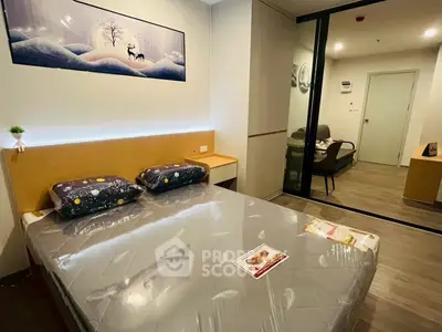 Modern bedroom with stylish decor and sliding glass doors leading to a cozy living area.