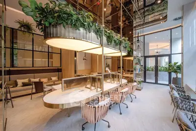 Luxurious modern lobby with elegant seating and lush greenery, perfect for welcoming guests in style.