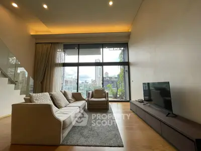 Luxurious living room with high ceilings and city view, featuring modern furniture and large windows.