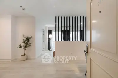 Modern open-plan living space with stylish partition and natural light