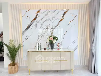 Elegant interior with marble accent wall and modern console table