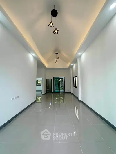 Spacious modern living room with high ceilings and elegant lighting in a luxury home.