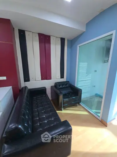 Stylish modern living room with leather sofas and unique wall design