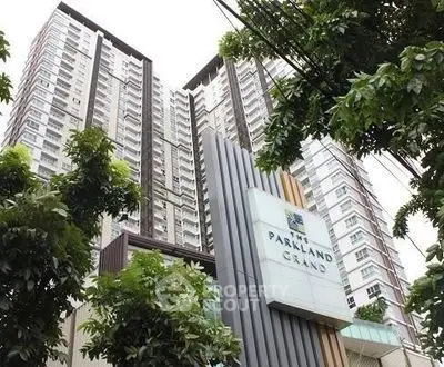 Modern high-rise building with lush greenery and elegant facade