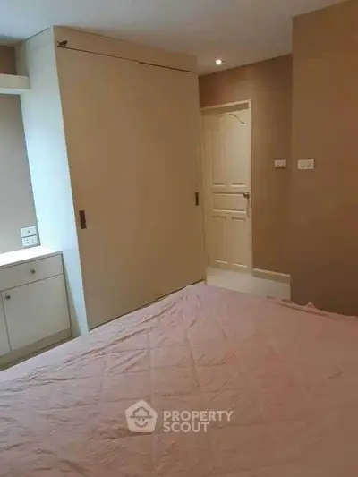 Cozy bedroom with built-in wardrobe and soft lighting